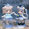 A pair of Mimia Art of Forgotten Dream Series collectible figurines featuring light pink and silver hair with blue accents.