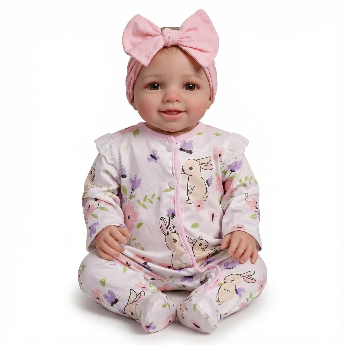 A realistic 18-inch reborn baby doll with a pink bow and floral print clothing.