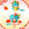 A blind box figure of Hatsune Miku in an orange fruit theme, featuring a clear display stand and accessories.
