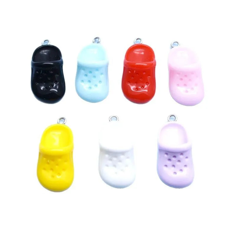 A set of six colorful DIY sunflower charms for jewelry making in black, light blue, red, pink, and yellow.