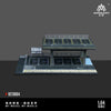A 1:64 scale mini garage diorama featuring a black and gray structure for diecast cars.