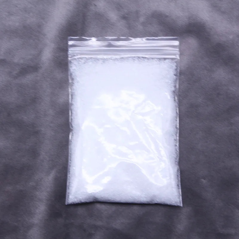 A clear plastic bag filled with white artificial snow powder.