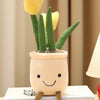 A cute plush toy resembling a tulip succulent plant with green leaves and yellow flowers growing out of a light-colored pot.