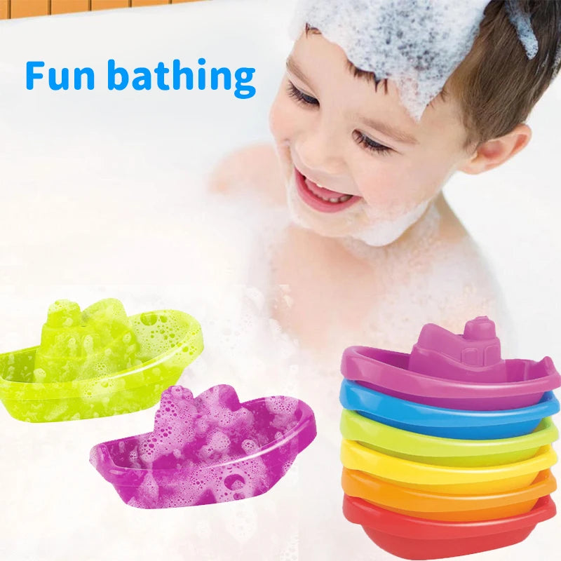 A young child is enjoying fun bathing with colorful stacking cups and floating boats in a bathtub.