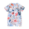 A baby rash guard swimsuit with short sleeves featuring a floral print in white, blue, and orange tones.