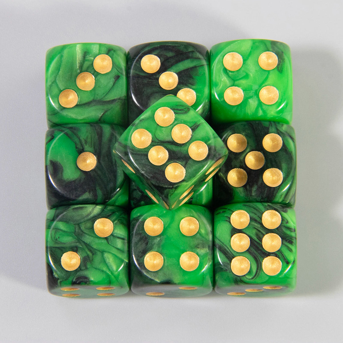 A set of ten green and black acrylic dice with gold dots and rounded corners.