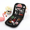 A black travel storage box containing a complete sewing kit with scissors, needles, and various tools.