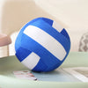 A blue and white striped soft plush volleyball pillow resting on a light green surface.