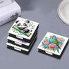 A DIY diamond painting animal pattern featuring a panda and a bird, displayed in storage boxes.