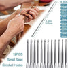 A set of 12 small steel crochet hooks in various sizes is being used to work with yarn.