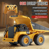 A yellow dump truck remote control vehicle with a yellow controller is shown on a textured surface.