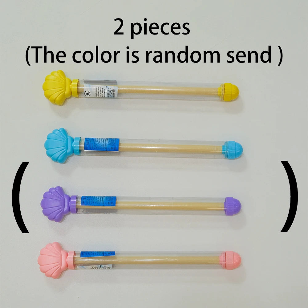 Four pull-out water guns in different colors yellow blue purple and pink displayed on a white background
