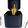 A black pop-up surprise gift box featuring a gold hand gesture on the lid.