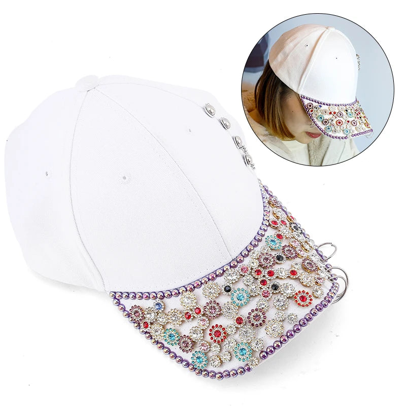 White baseball cap with a decorative, multicolored crystal glass sunflower claw rhinestone trim.