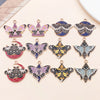 A collection of twelve colorful butterfly drop charms for jewelry making displayed on a light background.