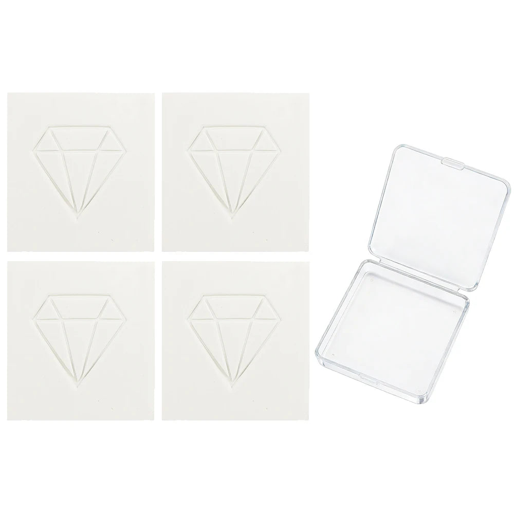 A set of four clear wax diamonds and an open clear plastic box for diamond painting craft.