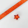 Orange glitter paper strips in a long strip with a small orange origami star attached.