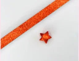 Orange glitter paper strips in a long strip with a small orange origami star attached.