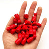 A hand holds a set of ten bright red wooden chess pawns for board games.