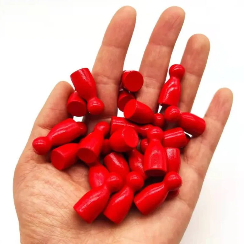 A hand holds a set of ten bright red wooden chess pawns for board games.