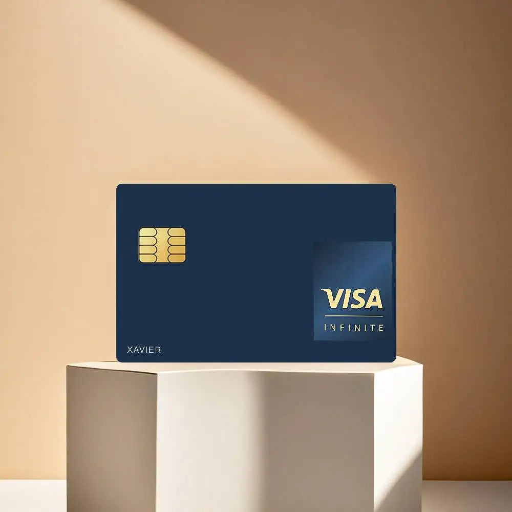 A dark blue card with a gold Visa Infinite logo and the name Xavier displayed on a white pedestal.