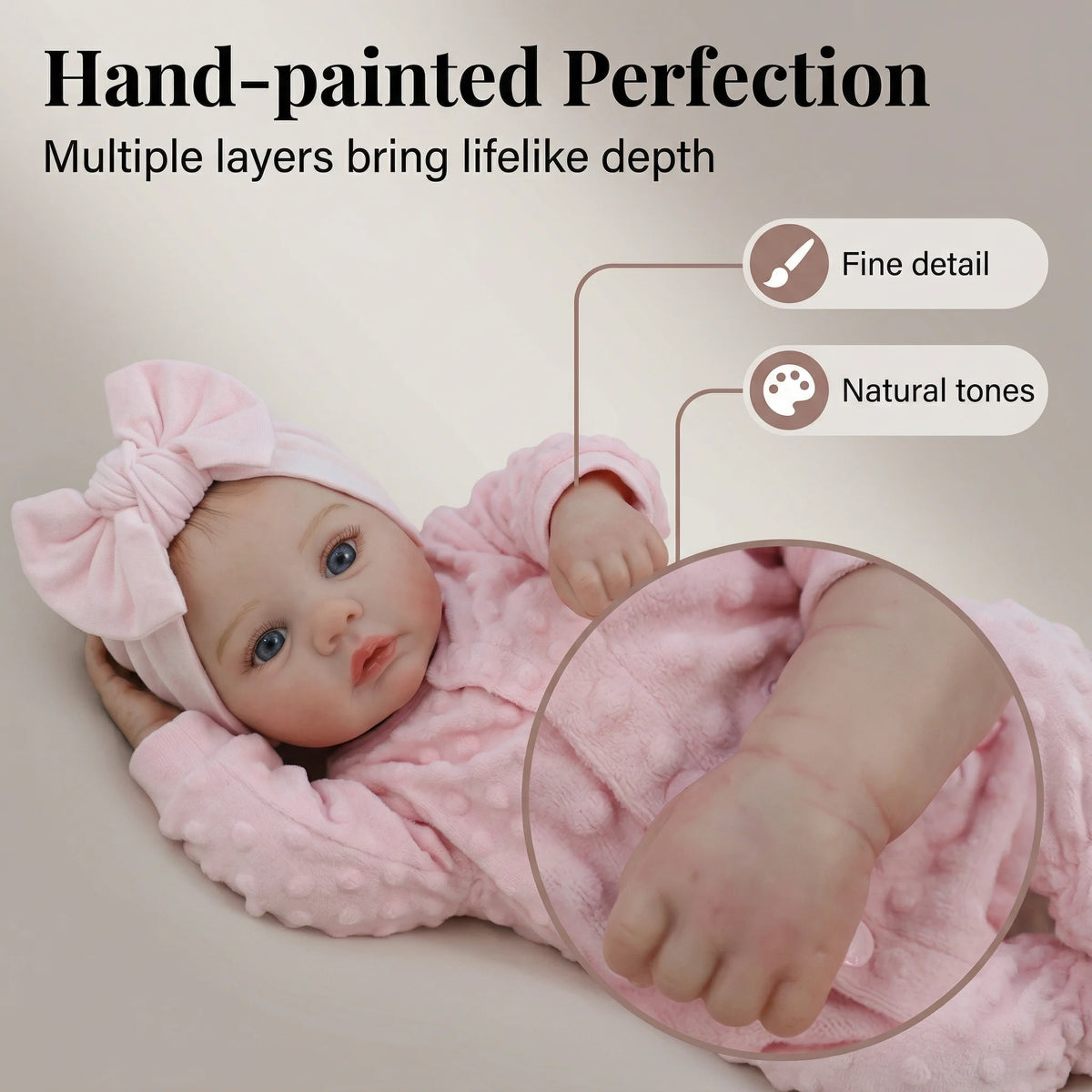 A hand-painted pink baby doll with lifelike features and natural tones.