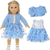A doll wearing a light blue winter coat and a matching blue tulle dress with floral accents.