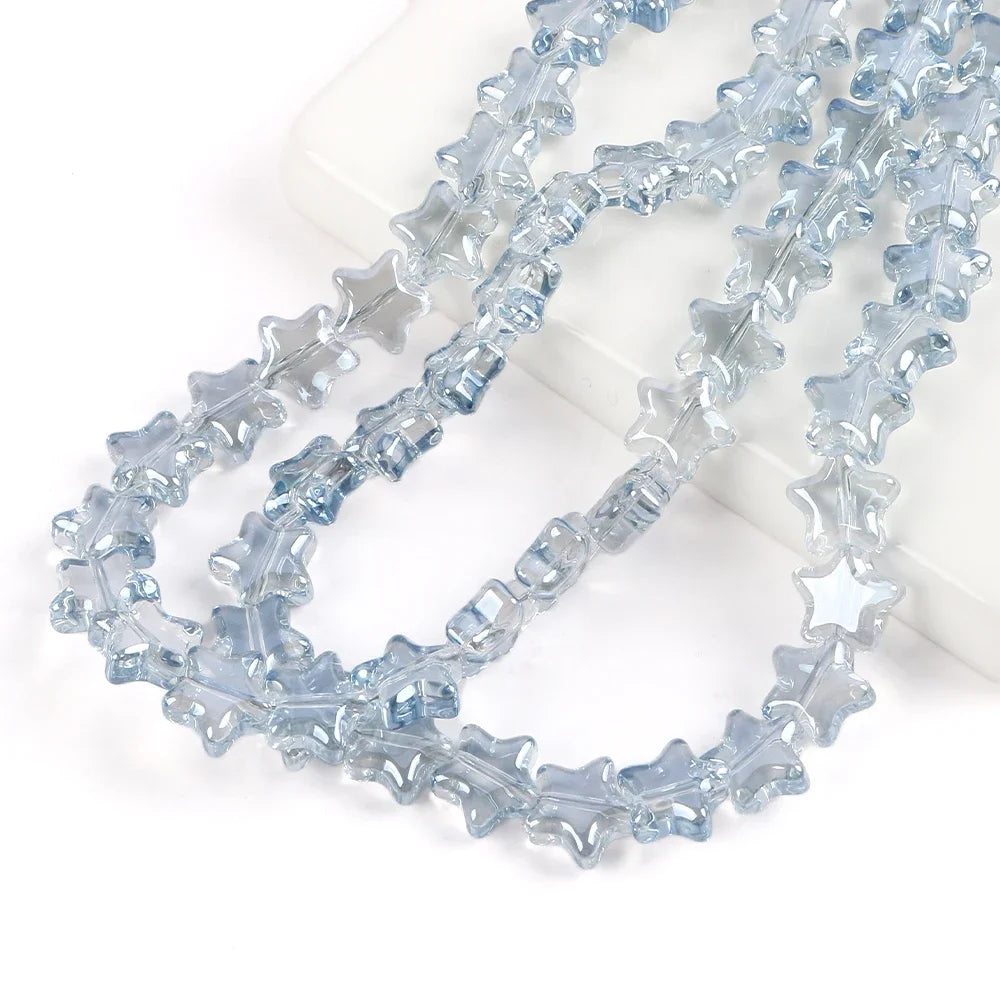 A strand of light blue glass star spacer beads for jewelry making