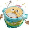 A light blue owl-shaped musical drum for kids with white sticks, shown in a close-up view.