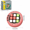 A box and a pink light-up rhythm game machine for kids featuring multiple colored buttons.