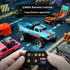 A hand holds a 2.4GHz remote control for an RC monster truck, with the truck visible in the background.