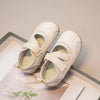 A pair of white girls' casual slip-on shoes with a breathable PU upper resting on a light surface.