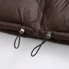 Close-up of a dark brown padded down vest with silver zippers and leather drawstrings.