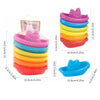 A set of colorful stacking cups and floating boats for bath time, stacked in various shades of pink, purple, blue, green, yel