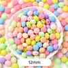 A close-up view of numerous pastel bear-shaped acrylic craft beads in various shades of pink, yellow, and blue scattered on a