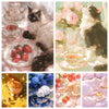 A collage of various sparkling cat art pieces, including a black and white cat, an orange tabby, and white cats, displayed in
