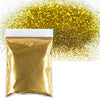 A package of gold holographic glitter powder next to a pile of loose gold glitter.