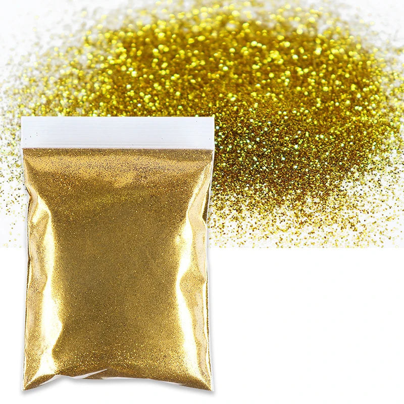 A package of gold holographic glitter powder next to a pile of loose gold glitter.