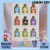 A display box showing various Lemon Toy mini figurines of cats in different colors and styles.