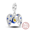 A sterling silver heart charm featuring diamonds and a blue moon design.
