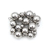 A cluster of small, spherical stainless steel magnetic clasps for jewelry making.