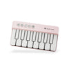 A pink mini piano with white keys and LED controls is shown from the side.