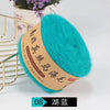 A ball of bright turquoise blue silk mohair blended yarn is displayed next to a gold wire rack.