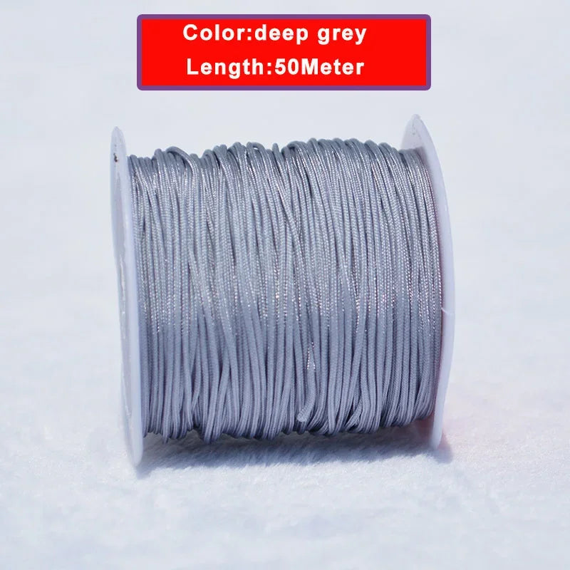 A spool of deep grey nylon knotting cord for jewelry making, measuring 50 meters long.