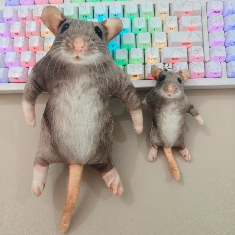 Two realistic gray rodent plush toys with long tails are displayed in front of a keyboard.