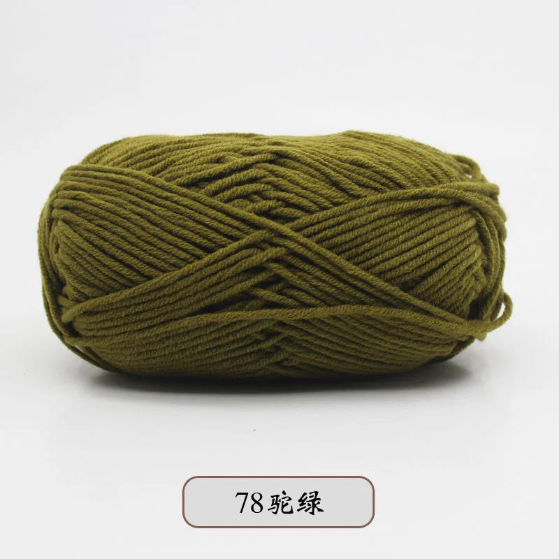 A ball of olive green pre-dyed milk cotton yarn used for knitting and crochet.