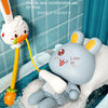 A cute rabbit-shaped electric bath shower toy with a yellow spray nozzle is shown in use in a bathtub.