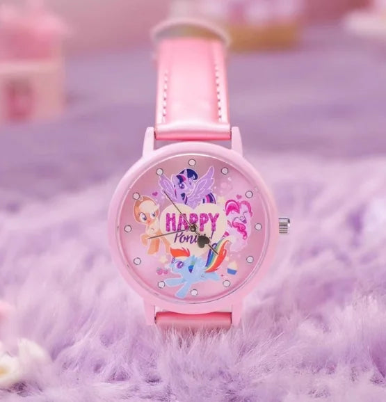 A pink My Little Pony Magic Sweetheart blind box watch with a pink strap resting on purple fuzzy fabric.