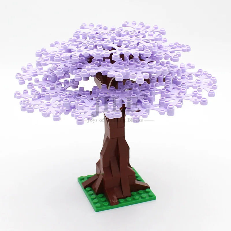 A model of a cherry blossom tree built from purple LEGO bricks standing on a green base.