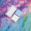 Two square wax pieces in white and light blue are displayed on a purple diamond painting background.